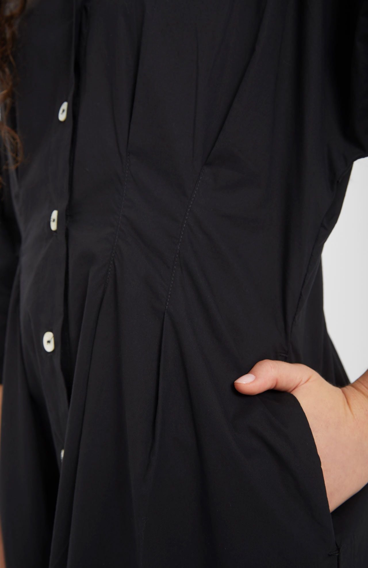 Model wears midi shirt dress in black