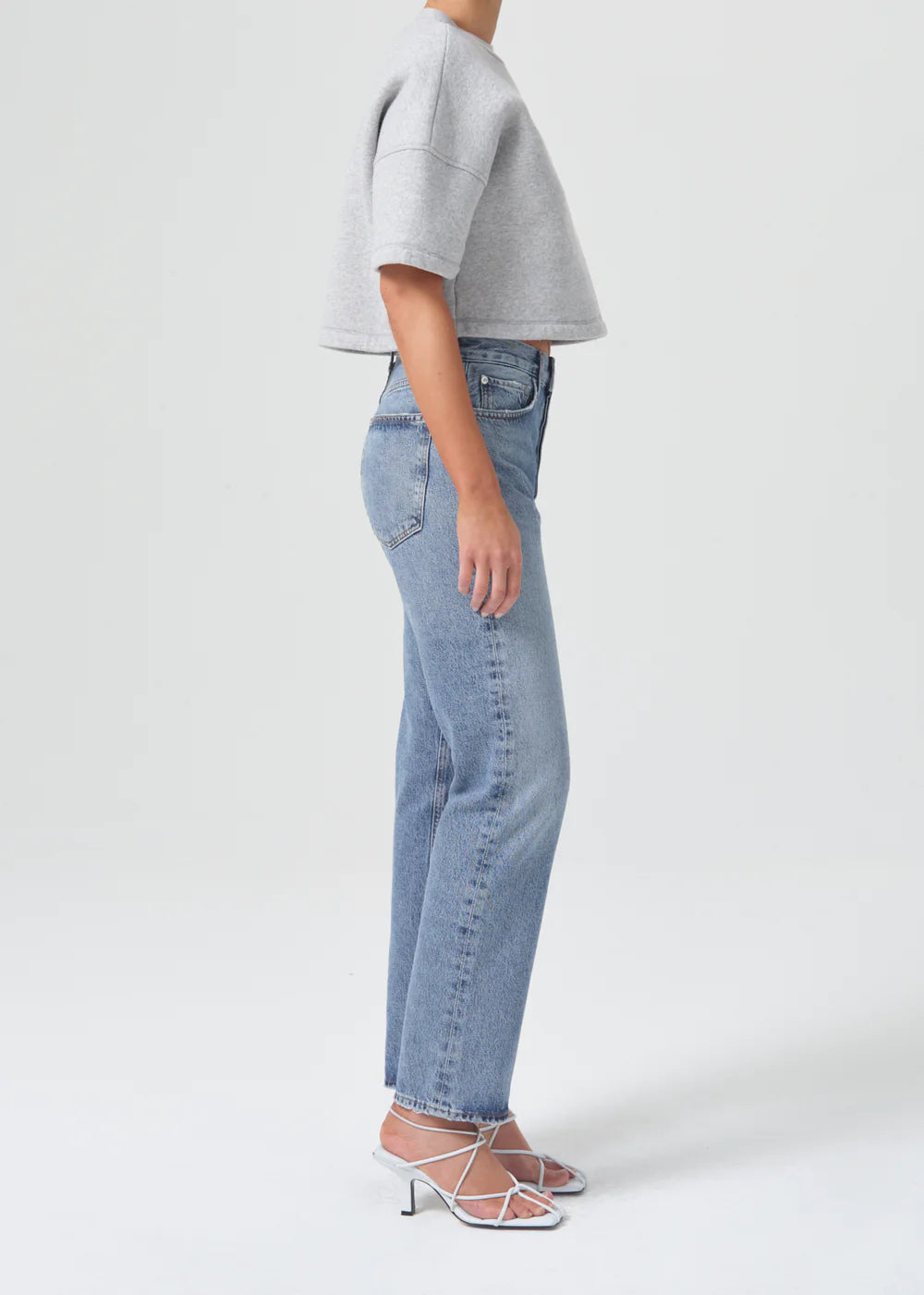 The model is wearing 90's Pinch Waist - Navigate jeans by AGOLDE.