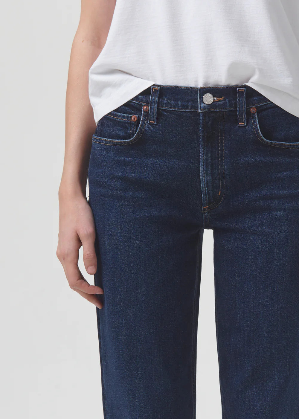 The back view of a woman wearing a pair of AGOLDE Kye Straight Crop - Song jeans in the slim fit Riley silhouette.