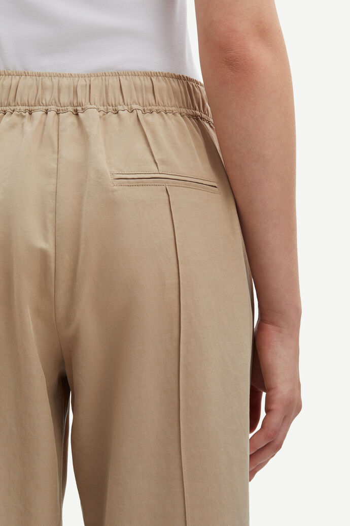 Beige high waisted tailored trousers. Ankle length.