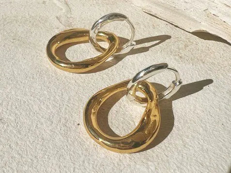A pair of intertwined SHYLA - Meridien Hoops - Gold earrings.
