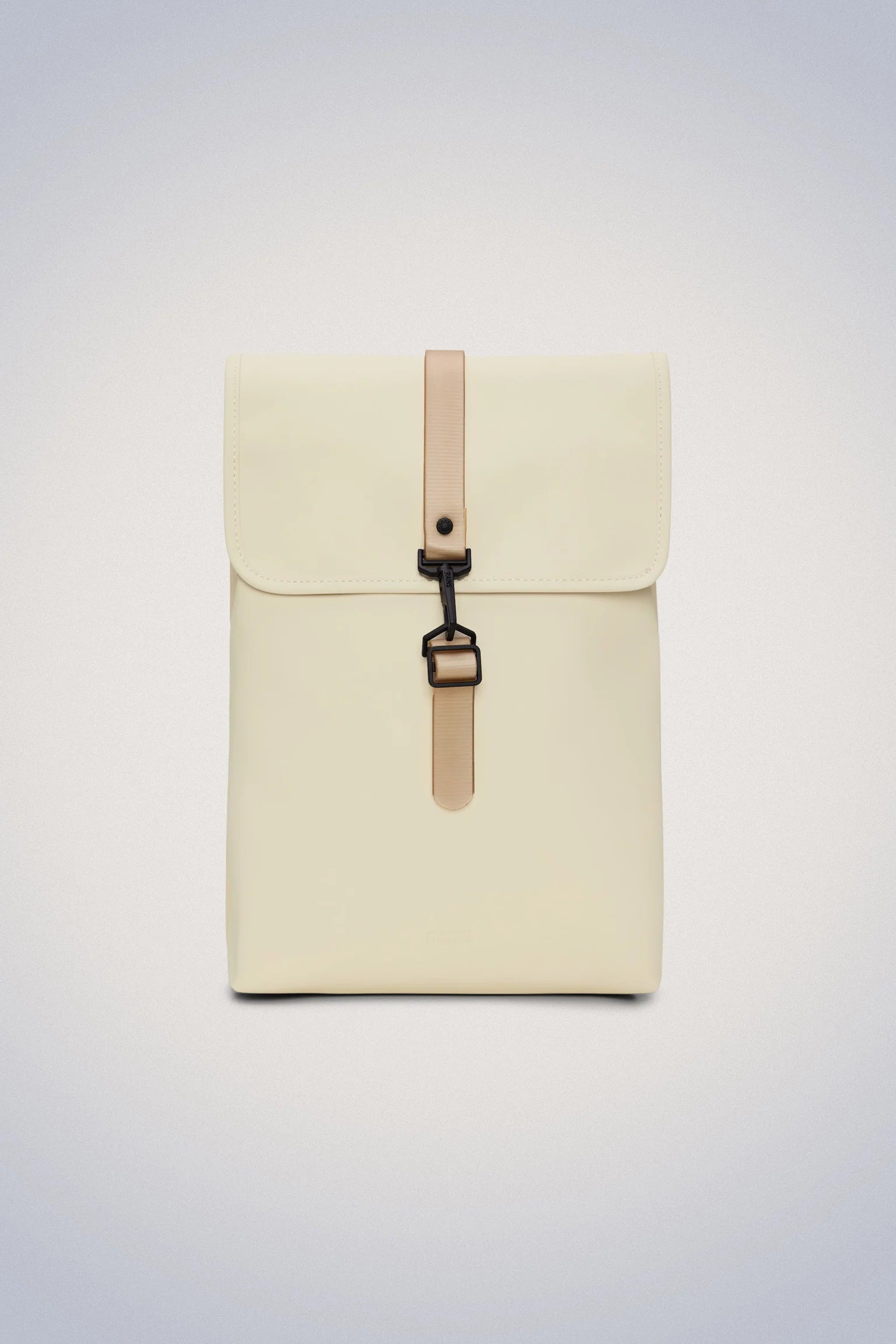 A small Rains rucksack in cream with tan straps.
