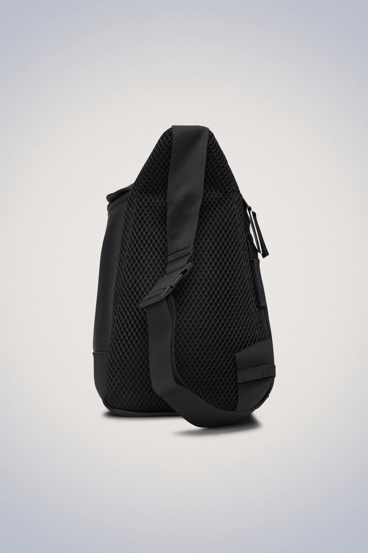 A compact Rains Trail Sling Bag - Black on a white background.
