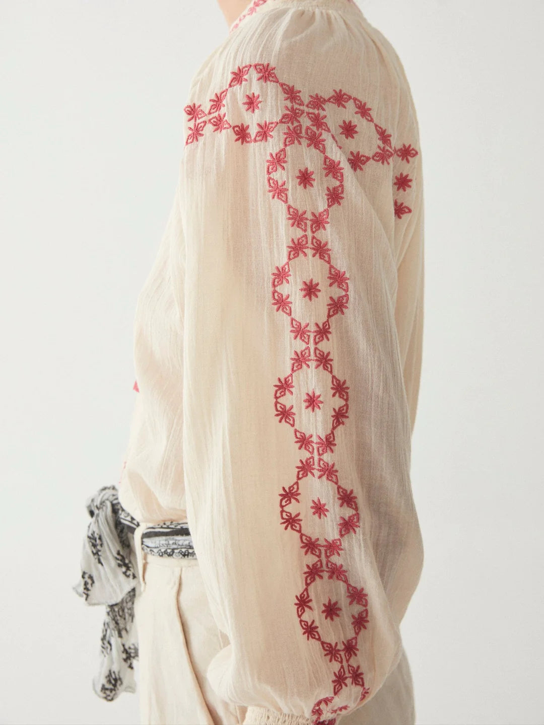 model wears off-white and pink embroidered blouse