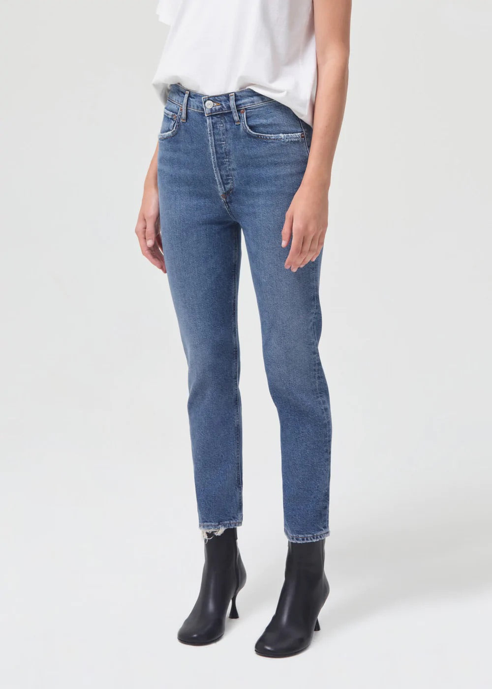The model is wearing a Riley Straight Crop - Silence t - shirt and denim jeans with a straight leg from AGOLDE.