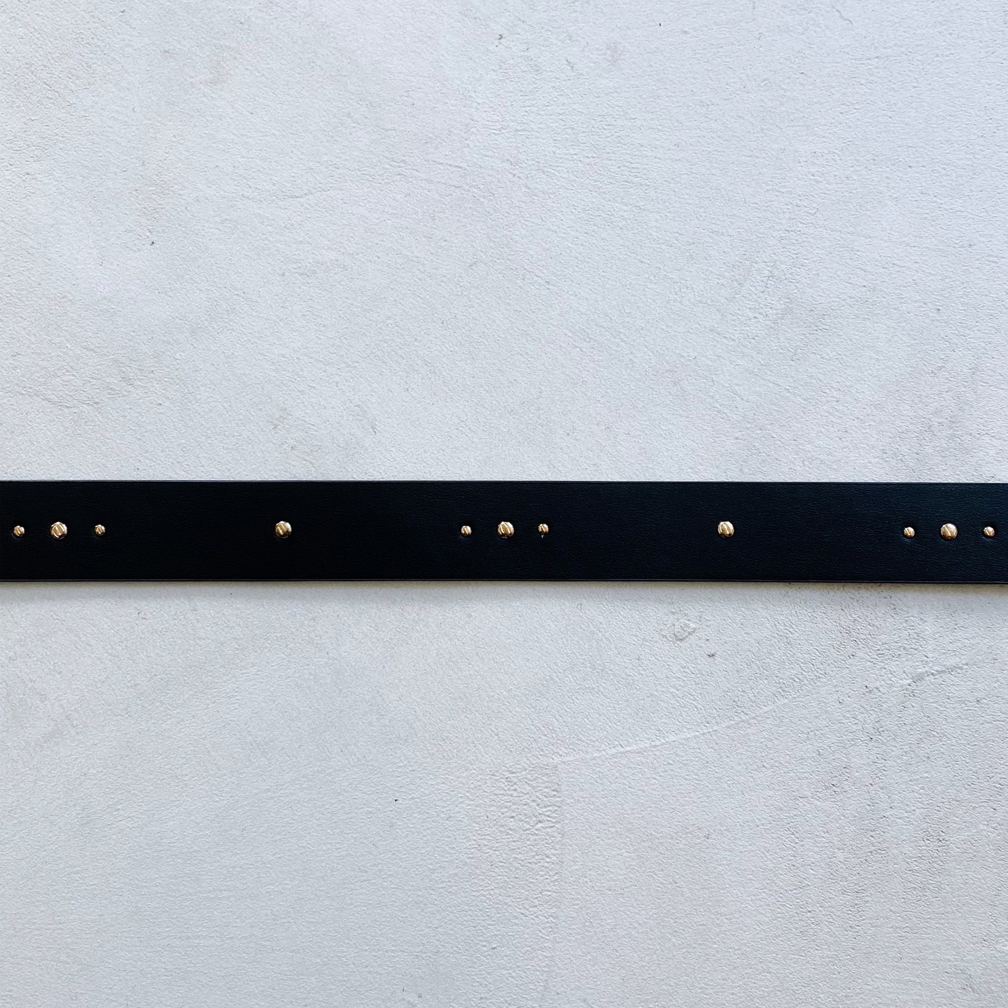 A Fabienne Chapot Studded Belt - Black with gold studs throughout.