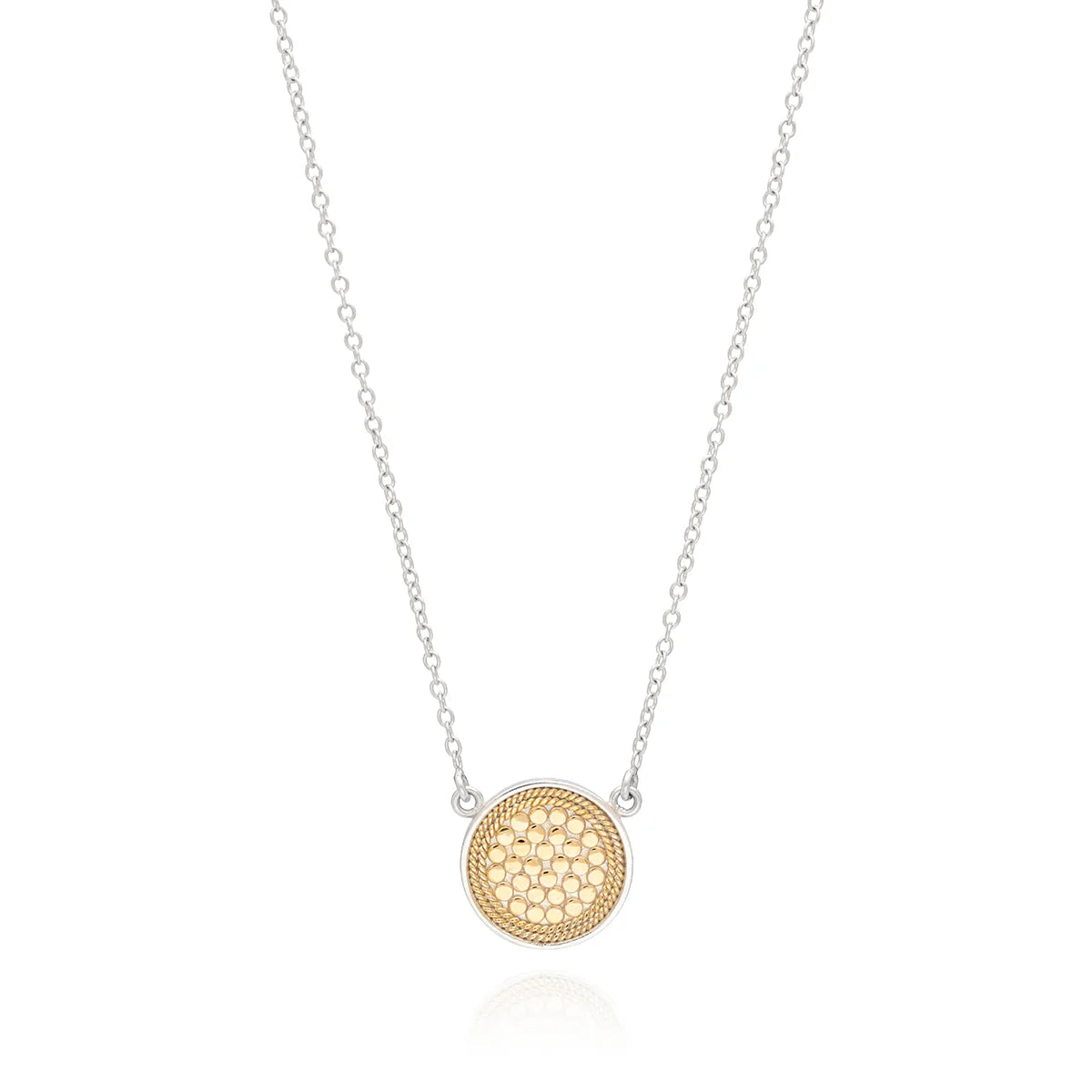 A thin sterling silver disc necklace with a circular gold-plated pendant featuring a honeycomb pattern in the center by Anna Beck, known as the Classic Disc Necklace - Gold.