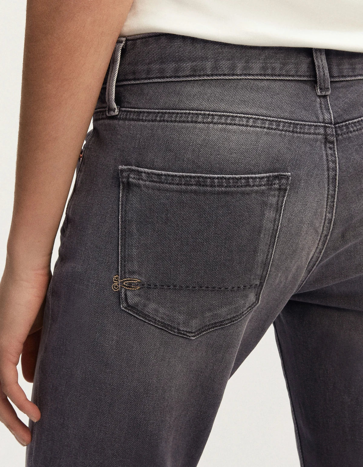 The back view of a woman in a pair of MONROE - Authentic Grey Wash jeans from Denham's Authentics range.