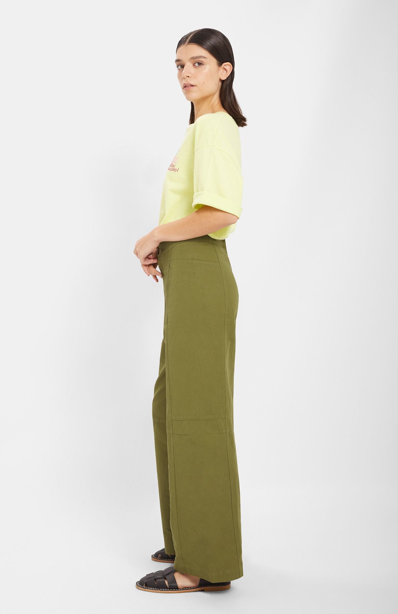 Model wears khaki green straight fit trousers