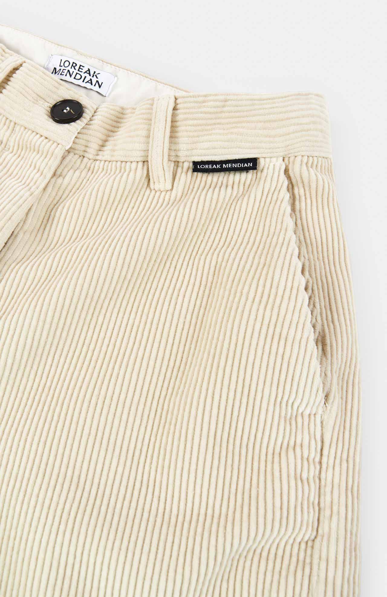 a flat product shot of cream cord trousers by loreak mendian