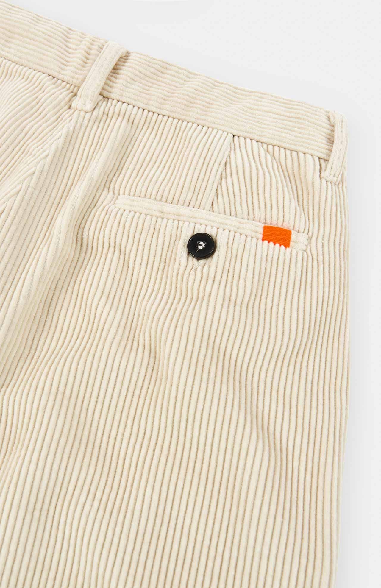 a flat product shot of cream cord trousers by loreak mendian