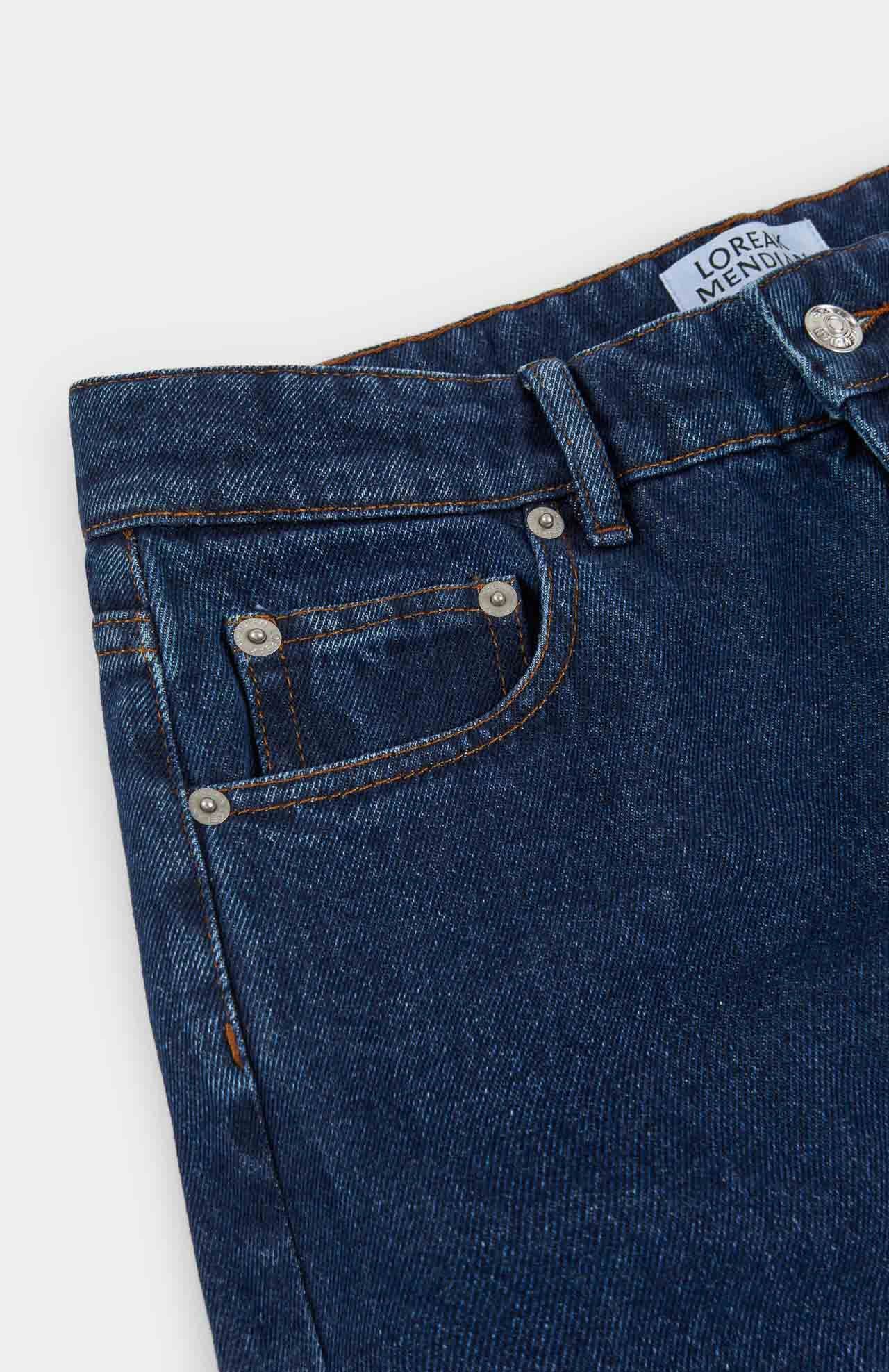 the corner view of a waistline of blue denim jeans