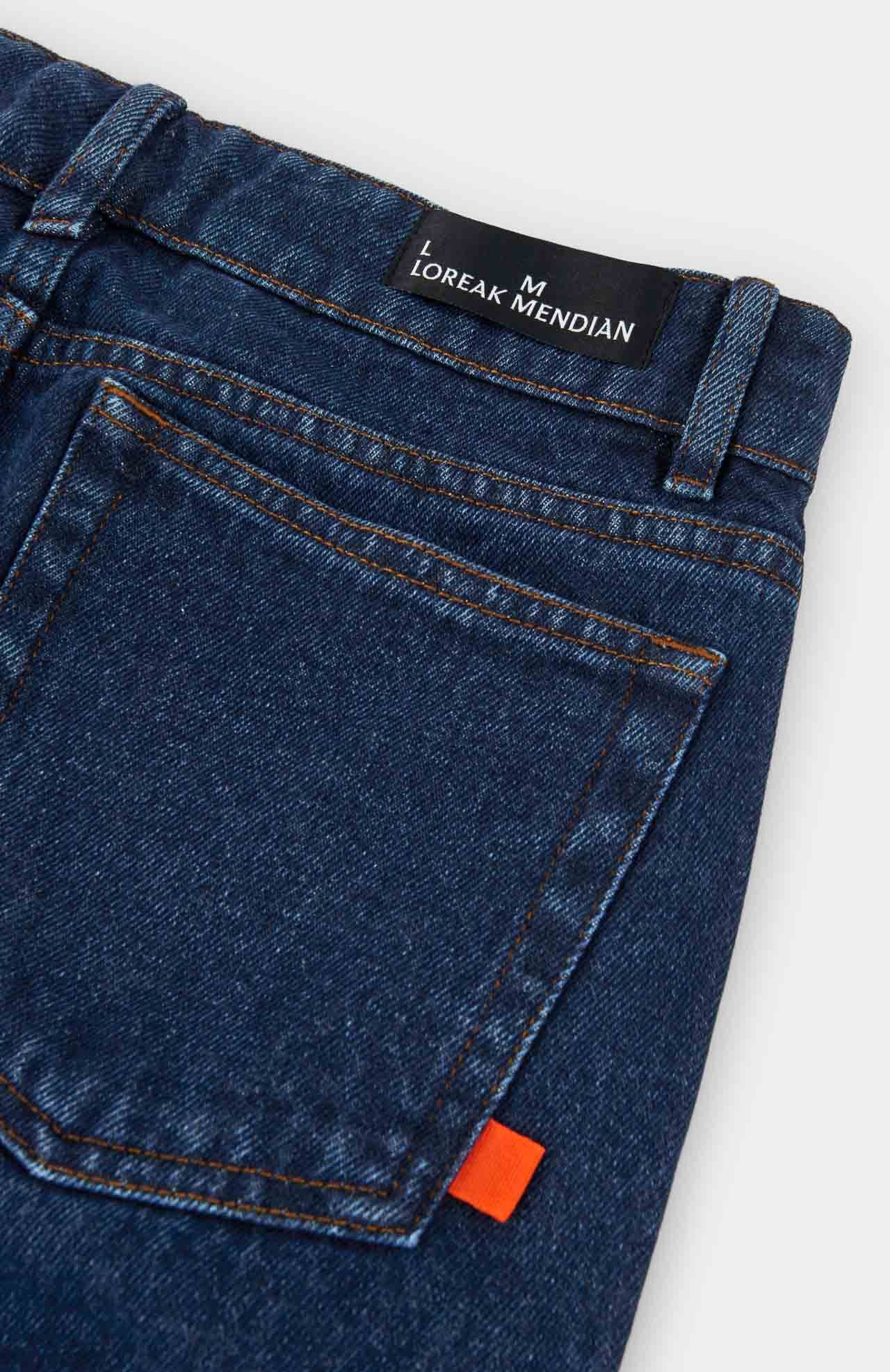 back pockets and belt loops on blue denim jeans