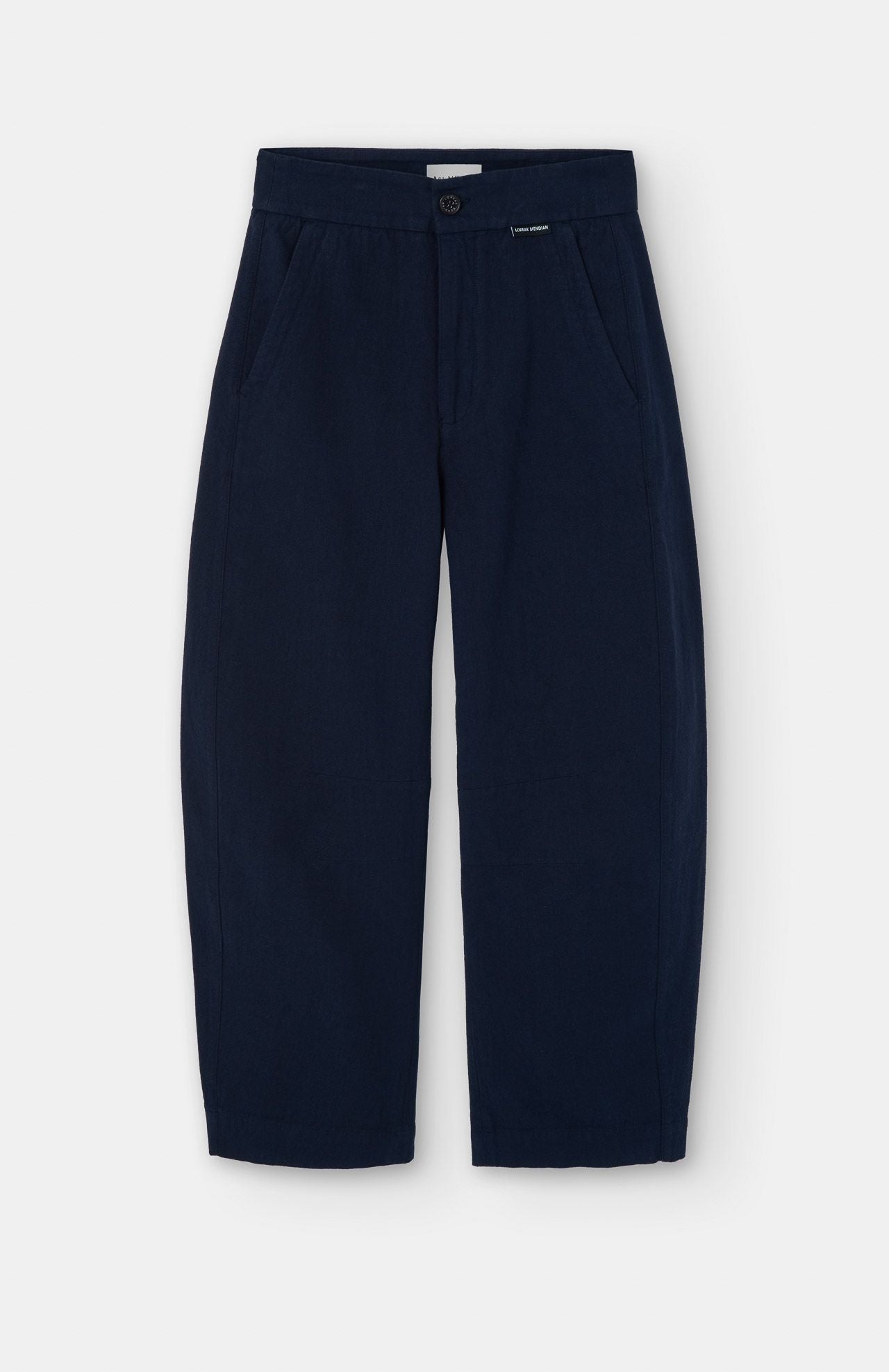 The Loreak Mendian Tome Barrel Trousers in navy feature a wide-leg barrel cut, side pockets, and button closure, shown flat on a white background.