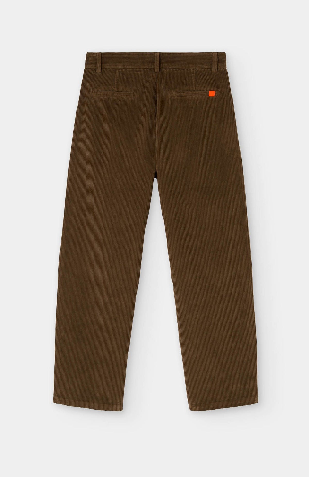 The Bana Barrel Leg Cord Trousers in Dark Camel by Loreak Mendian are laid flat and viewed from the back, showcasing two back pockets and a distinctive small orange tag on the right pocket. Made from 100% cotton, these corduroy pants combine classic comfort with timeless style.