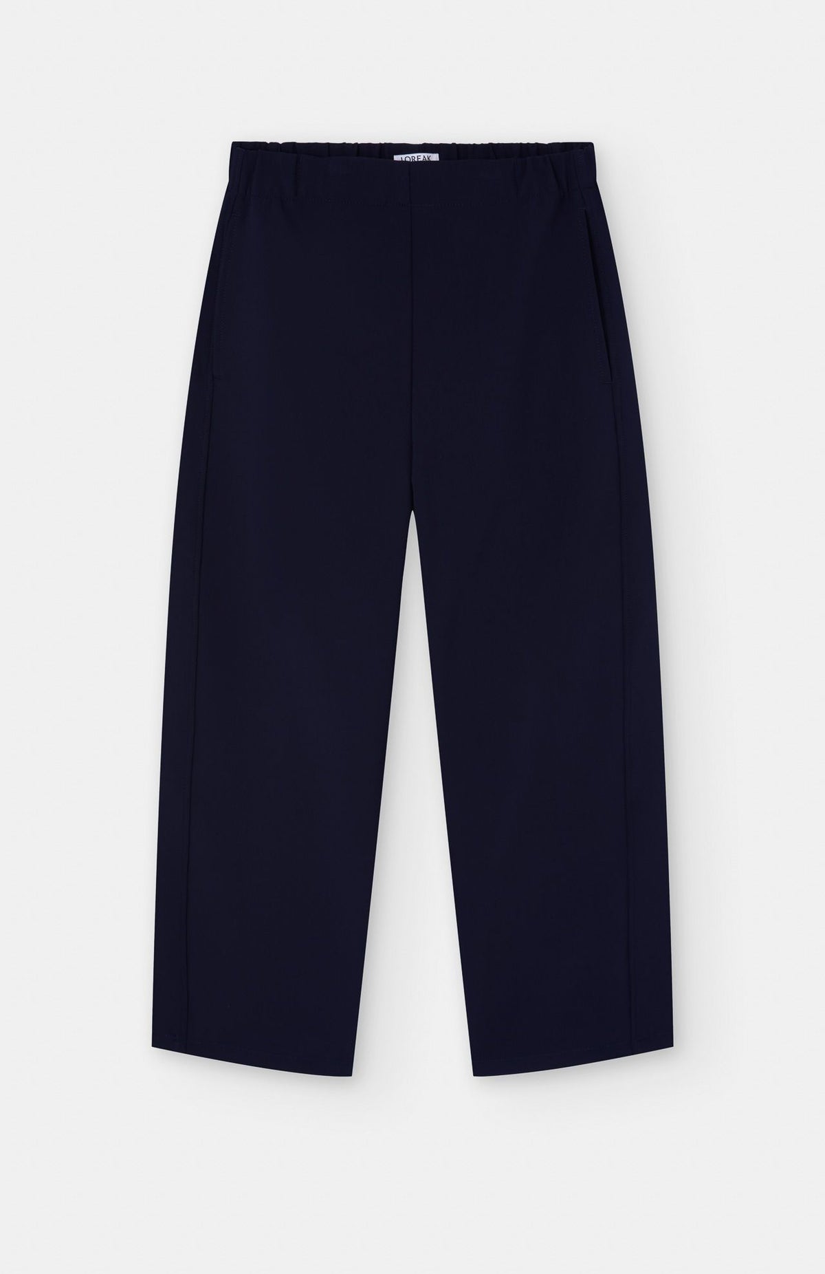 navy blue barrel shaped jogger trousers on a white background