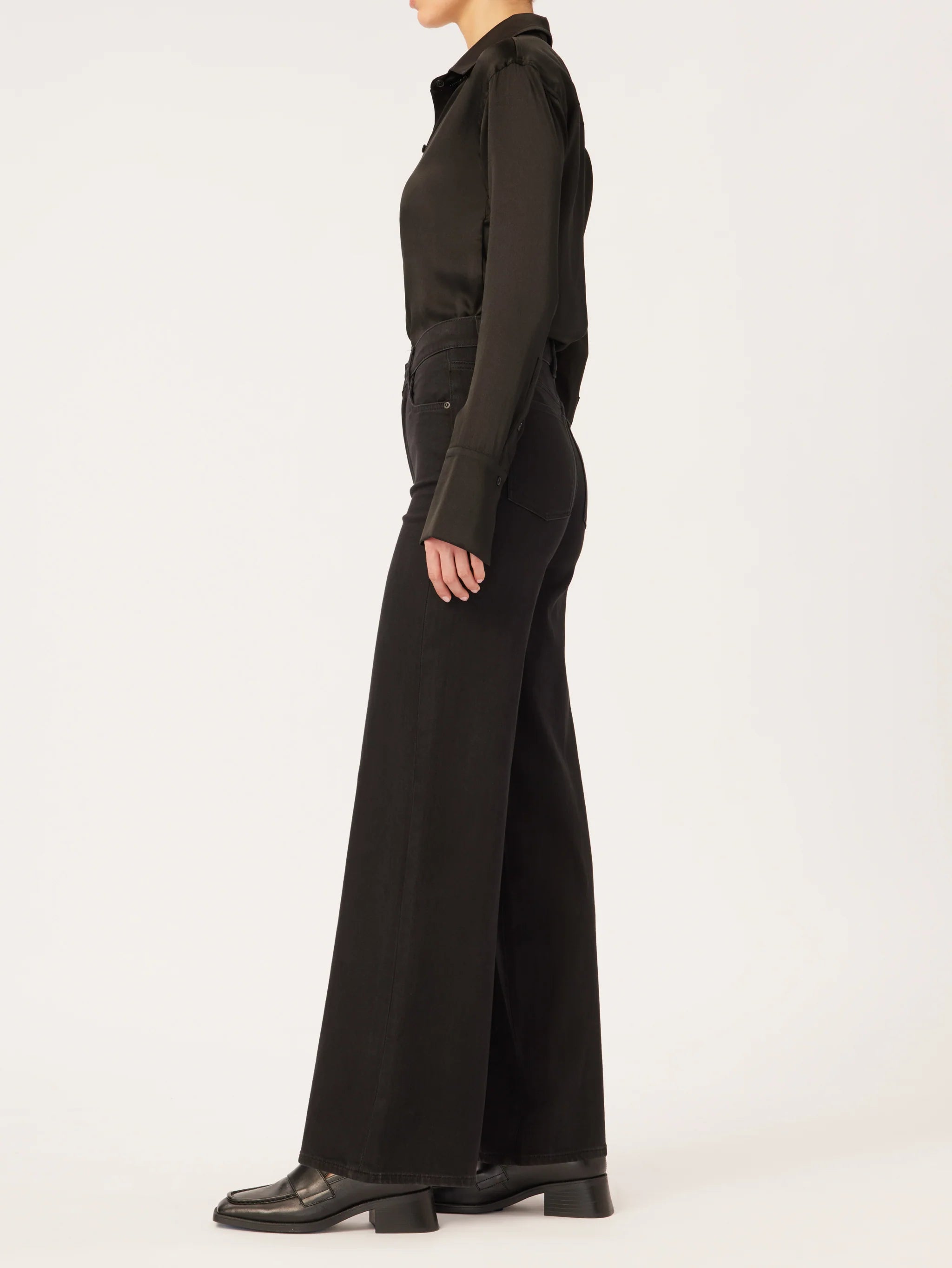 The back view of a woman wearing DL1961's Hepburn Wide Leg - Jet Black trousers with a vintage high-rise.