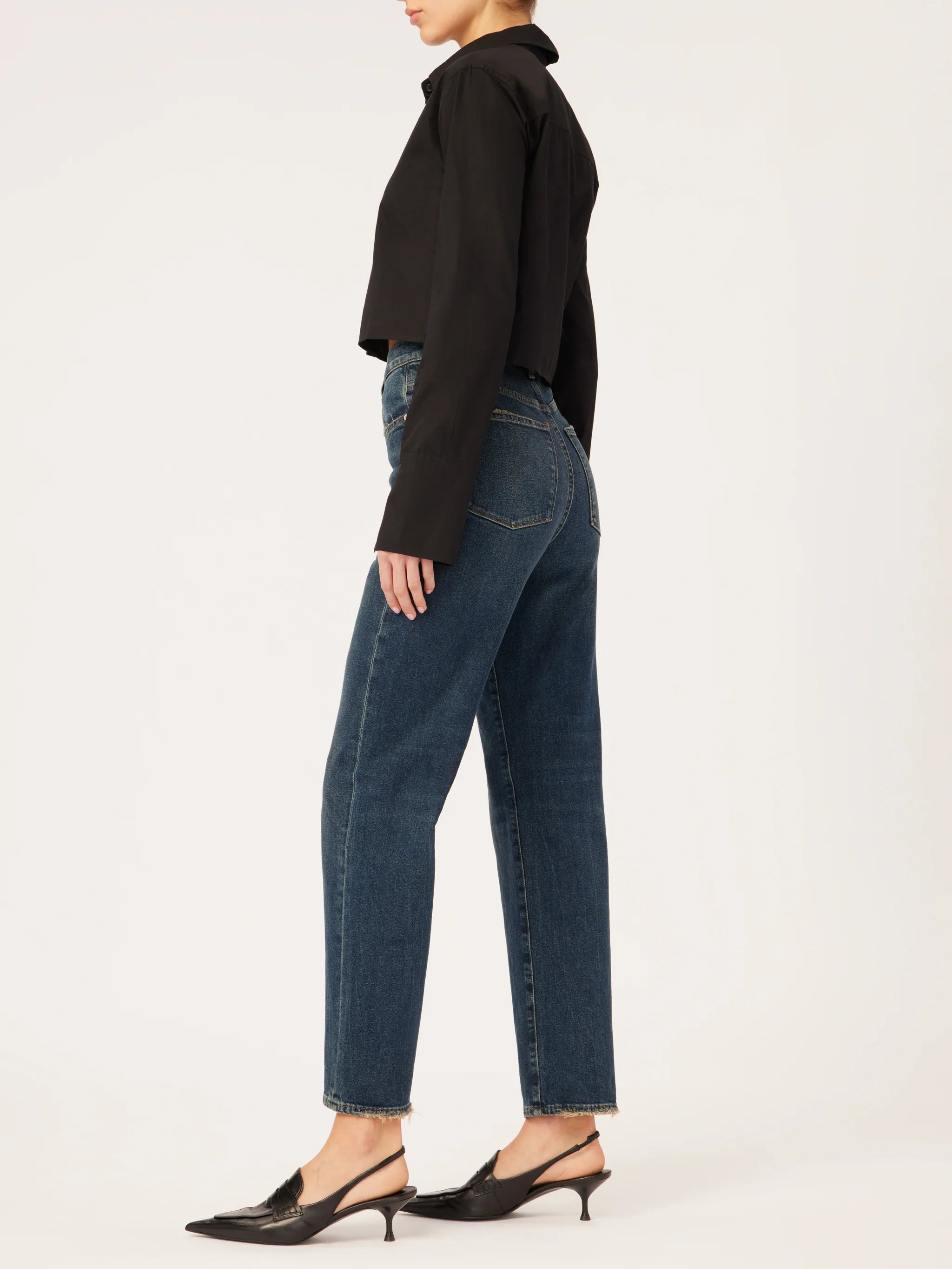 The back view of a woman wearing DL1961 Enora Cigarette High Rise - Broadbay jeans and a black jacket with an ultra high-rise and 29" inseam.