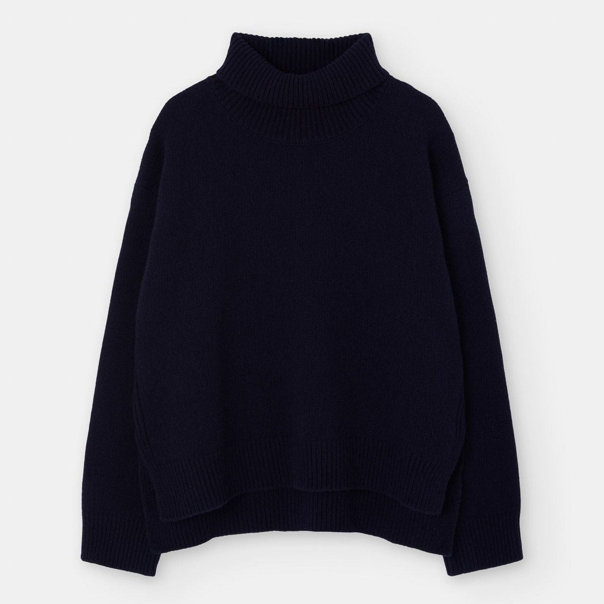 A dark navy blue knit turtleneck sweater displayed against a clean, light gray background.