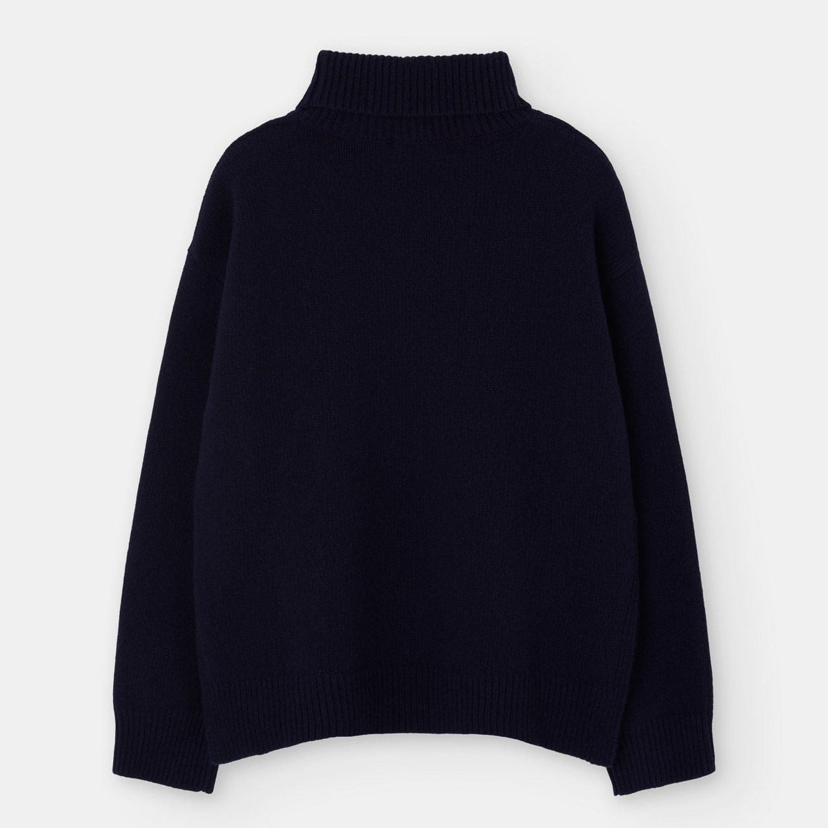 The Loreak Mendian Isla W Wool Rollneck Knit in navy is shown against a white background, expertly crafted from eco merino wool for a sustainable and cozy layering essential.