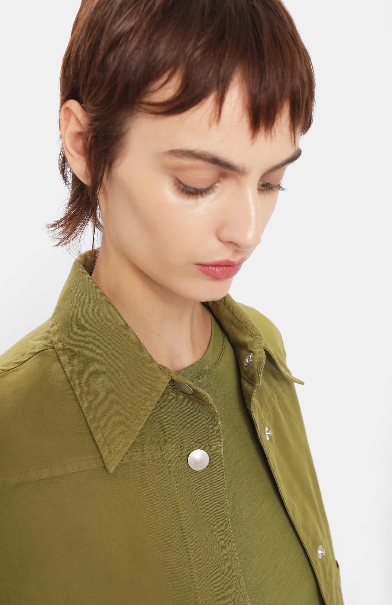 Model wears cropped jacket in khaki green