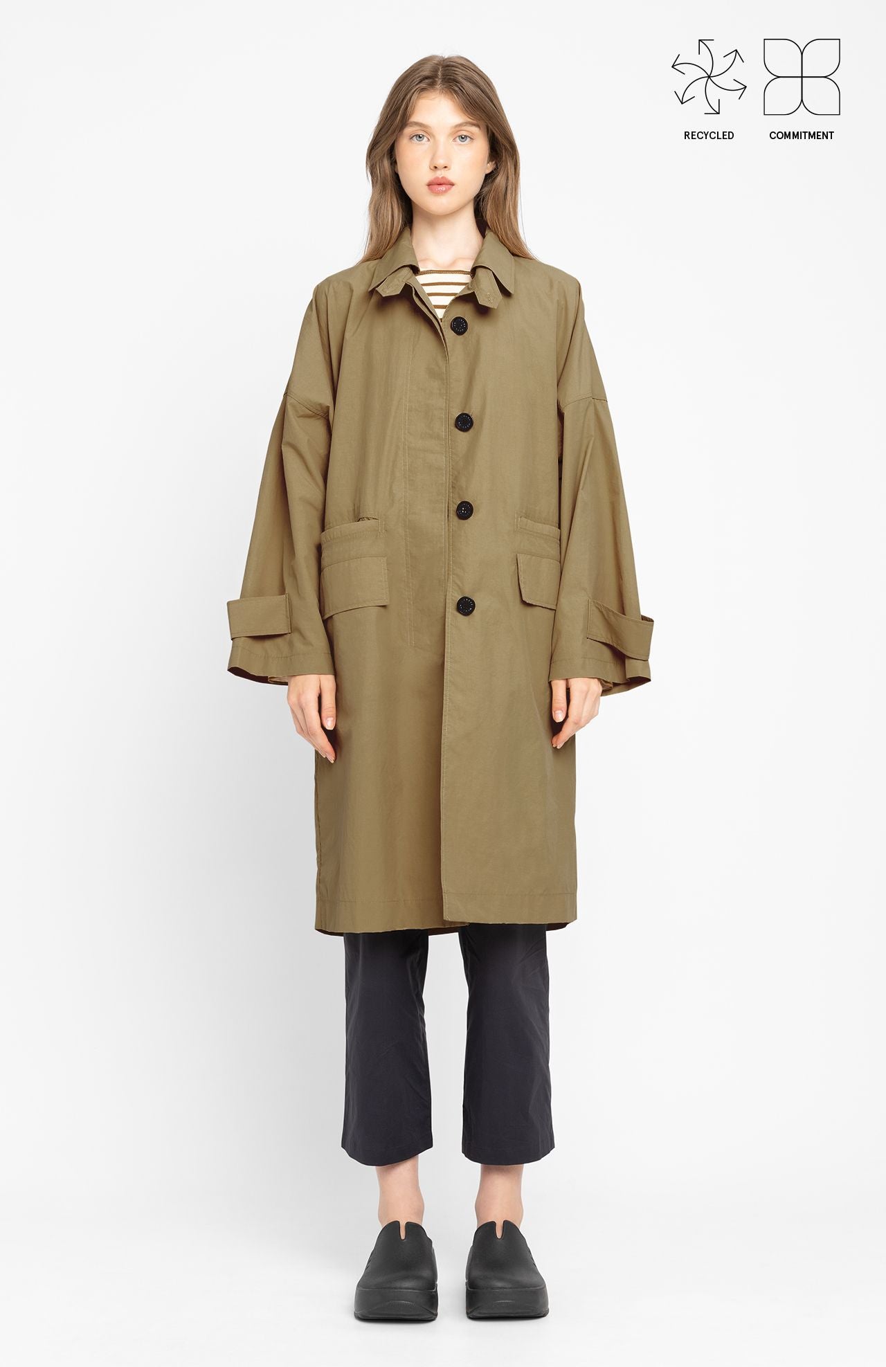 A person wearing the Loreak Mendian Lizaso Jacket in camel, paired with black pants and shoes, stands facing the camera against a plain white background.