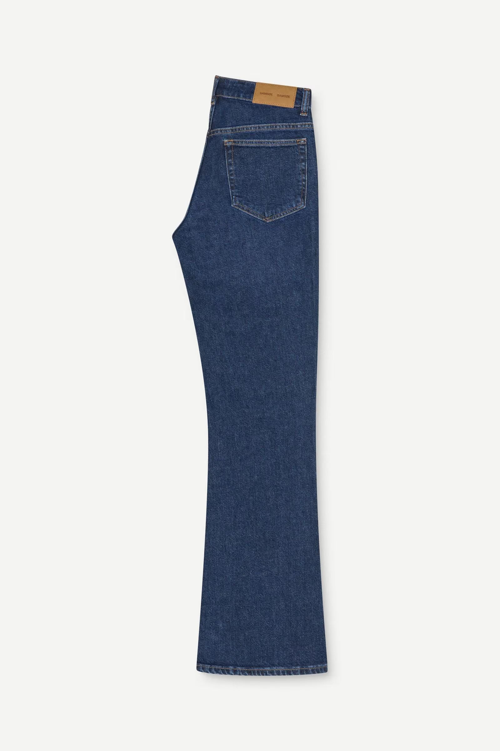 A side view of the Salella Jeans - Paris Blue by Samsøe Samsøe, a pair of mid-rise blue denim jeans featuring a single back pocket and a brown leather patch on the waistband.