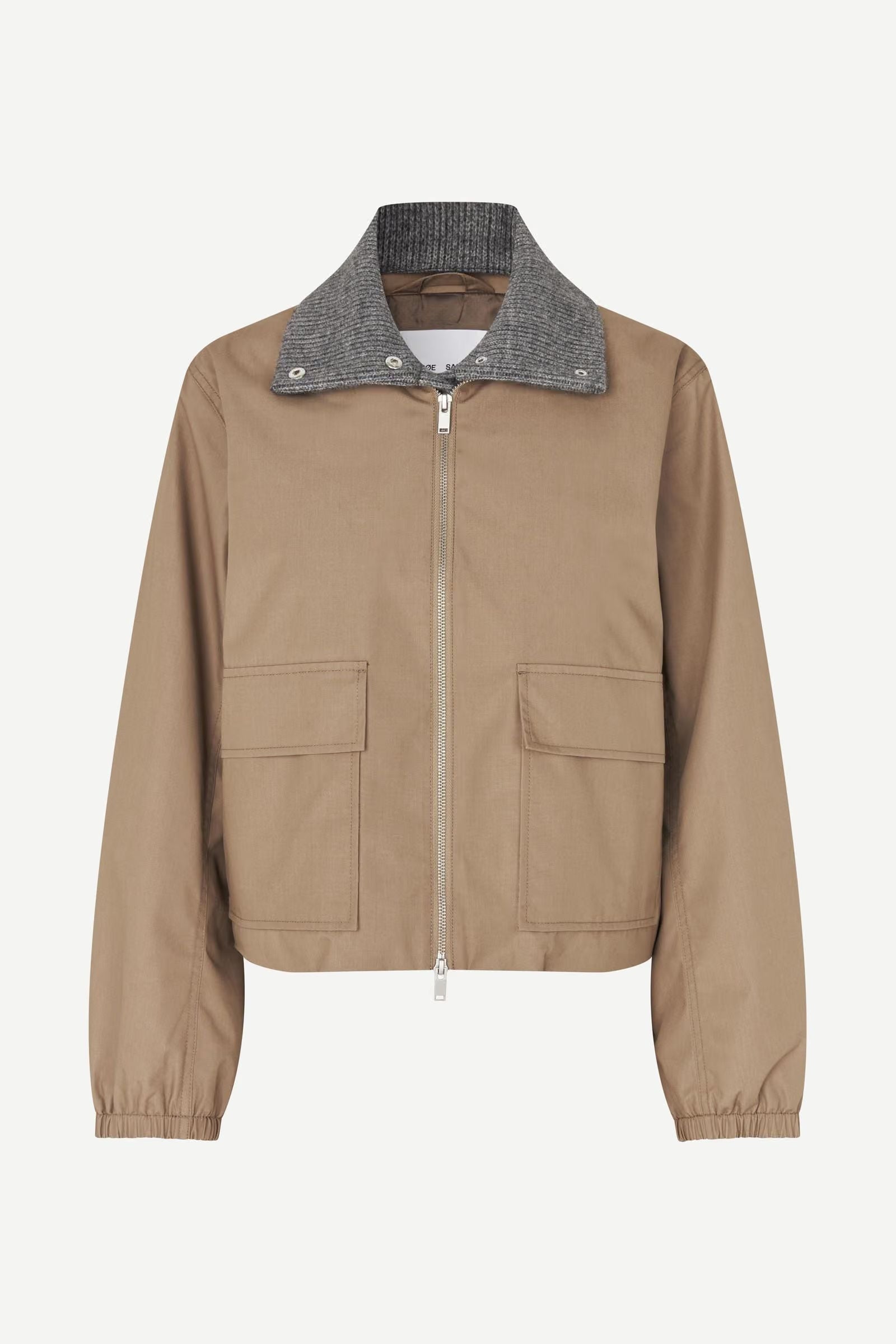 The Sabianco Jacket - Lead Grey by Samsøe Samsøe is a zip-up, lightly padded jacket featuring two front pockets, elastic cuffs, and a contrasting gray ribbed collar. Made from recycled polyester, it is shown here against a plain white background.