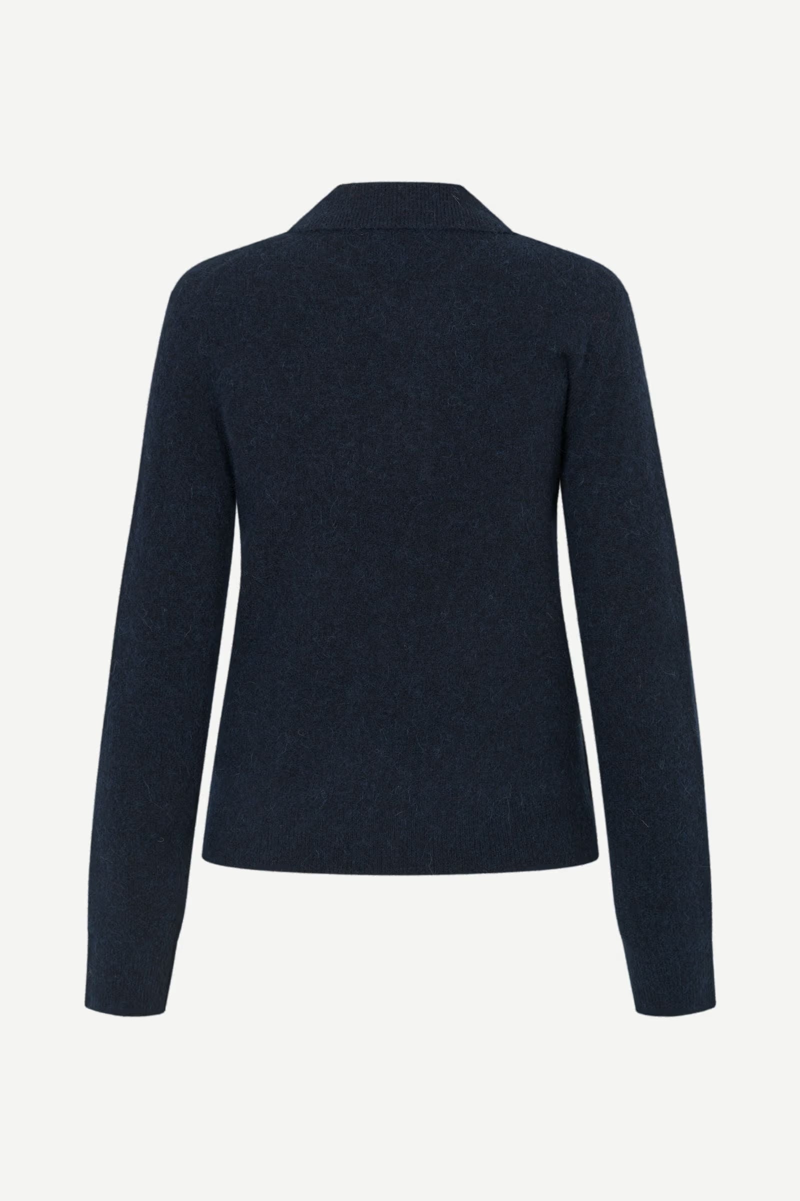 The Sanoura LS Polo in navy by Samsøe Samsøe is pictured from the back, showcasing a straight hem and flat polo collar. Made from a soft wool-alpaca blend, this long-sleeve sweater provides warmth and style for cooler days.