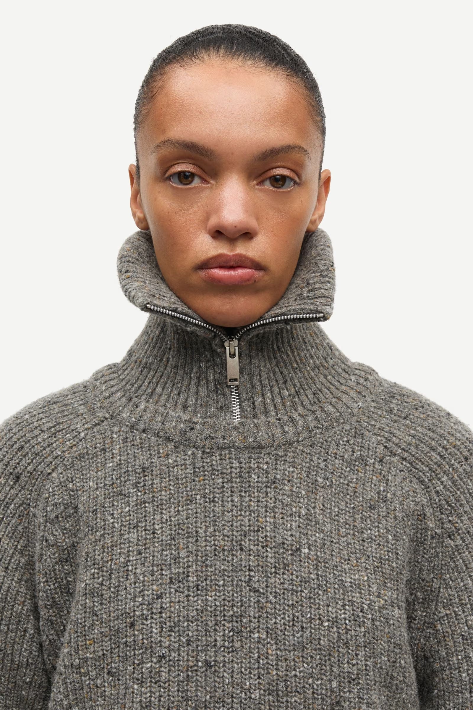 A person is wearing the Saamandy Turtleneck in Lead Grey Melange by Samsøe Samsøe, facing forward with a neutral expression against a white background.