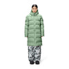 person wears the matt light green long padded puffer by raind over monochrome cargo pants and black boots