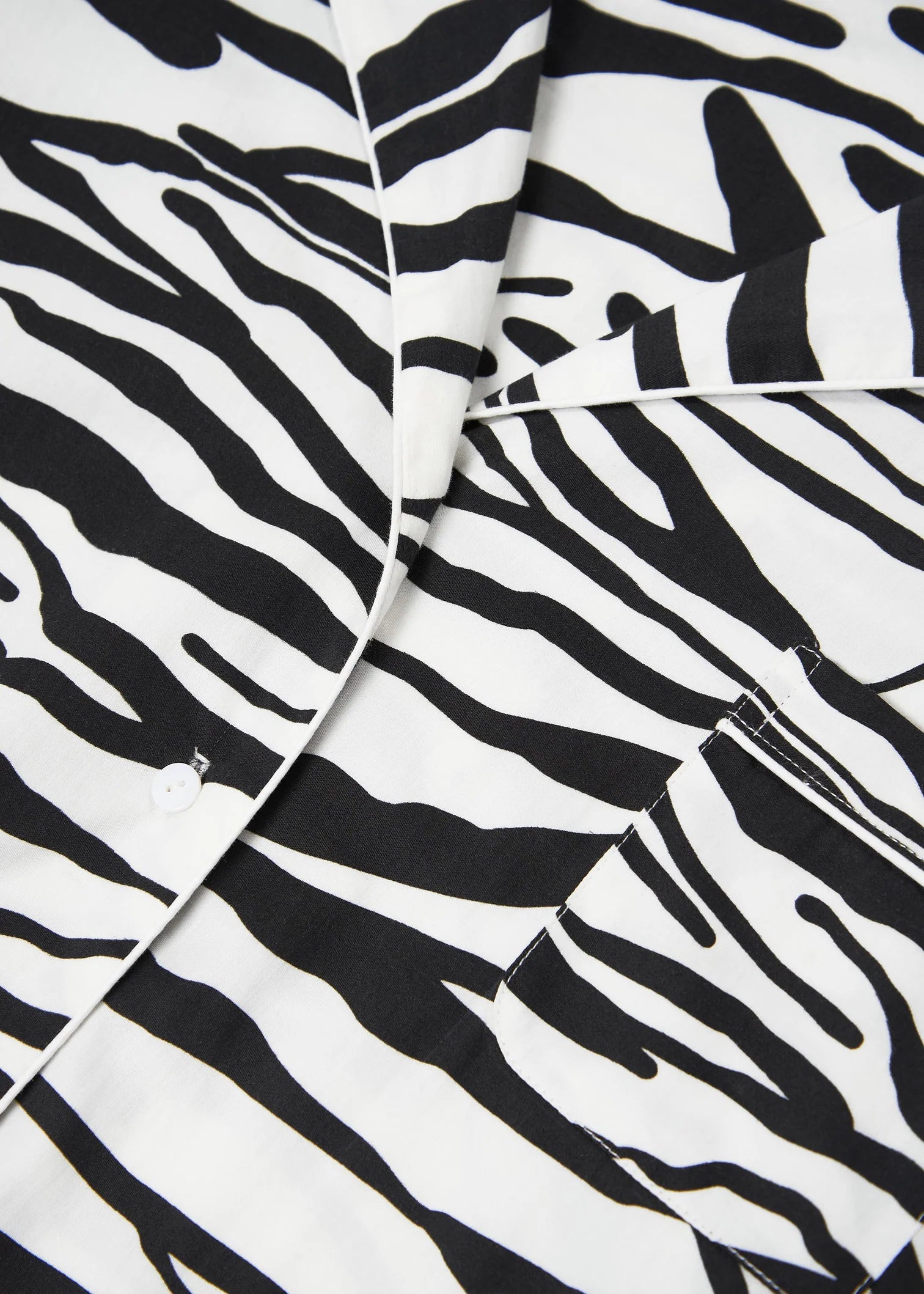 A close up of a soft, BREATHE Monochrome Tiger organic cotton pyjama top.