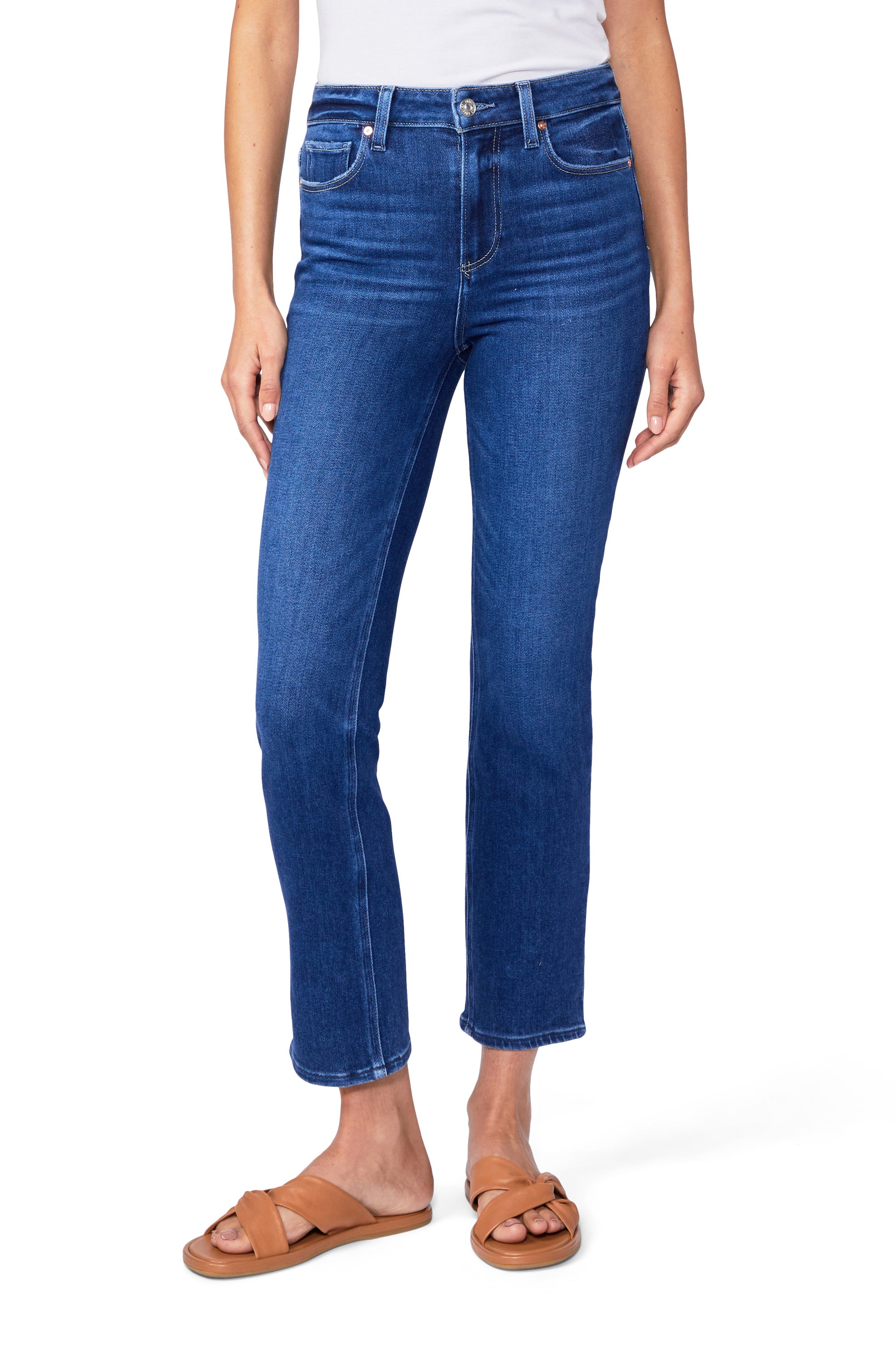 A woman is wearing a pair of Paige Cindy Straight Ankle - Soleil jeans.