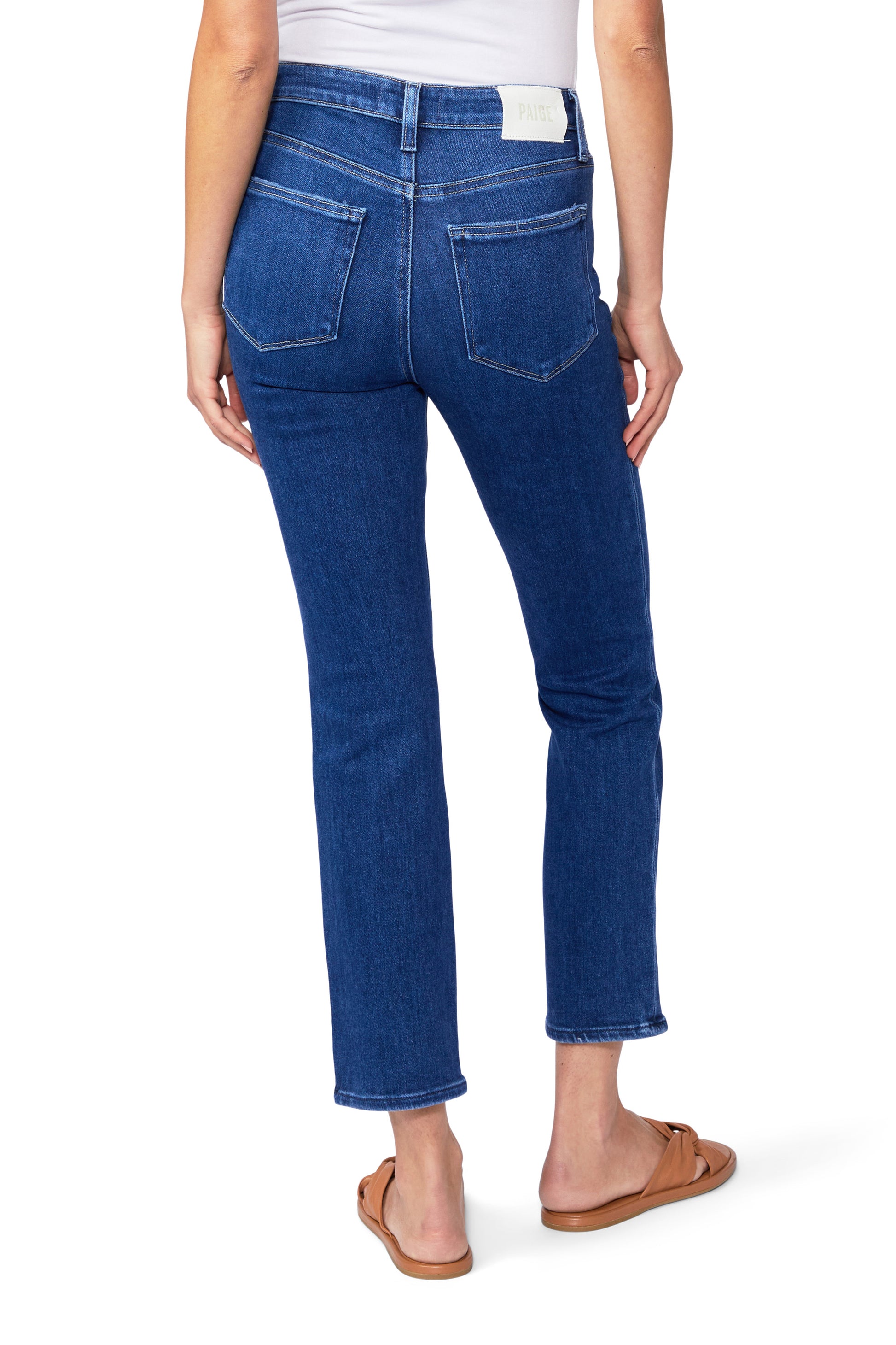 The high rise back view of a woman wearing Paige Cindy Straight Ankle - Soleil denim jeans.