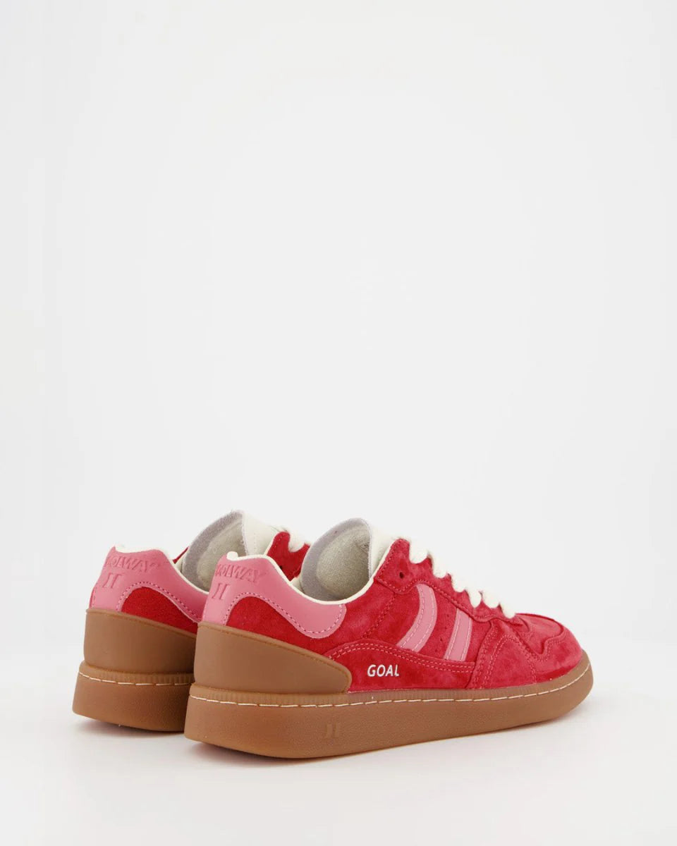 A pair of Coolway Goal Sneakers - Red Love, featuring red and pink suede leather with white laces and brown rubber soles, are placed facing away from each other on a white background.