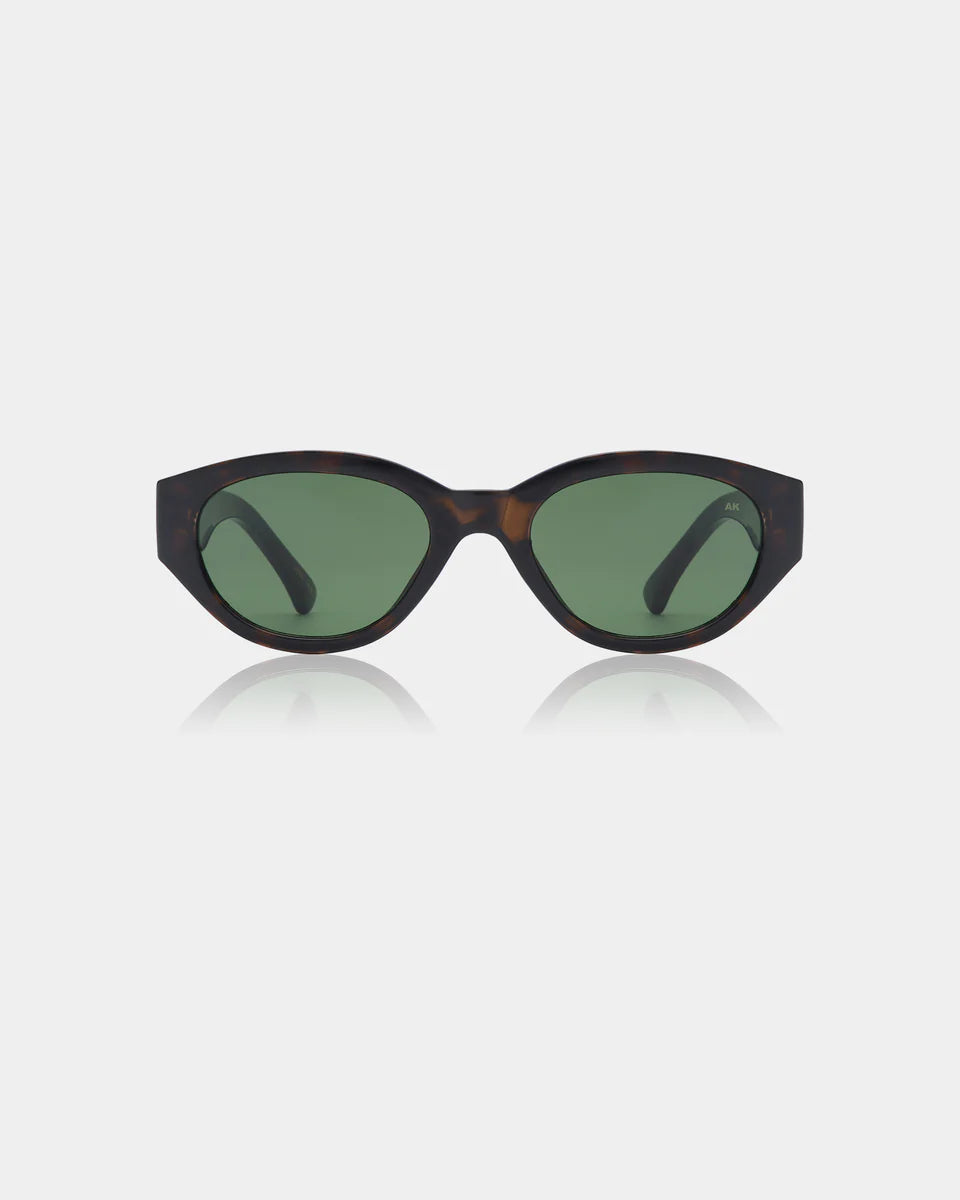 The Winnie Sunglasses by A. Kjærbede feature an oval shape, demi tortoise recycled frames, and green tinted lenses, shown against a plain white background.