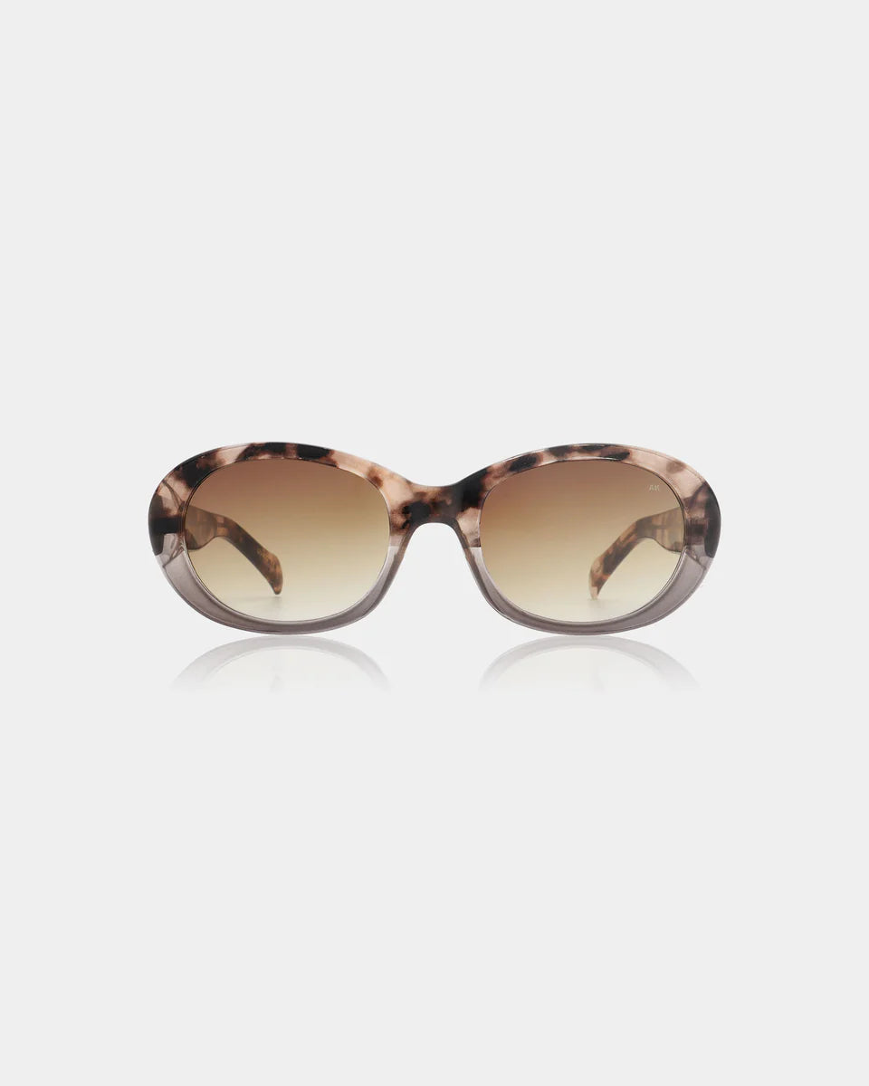 The Anma Sunglasses by A. Kjærbede in Coquina / Grey Transparent feature an oval-shaped frame and gradient lenses with UV 400 protection, shown against a plain white background.