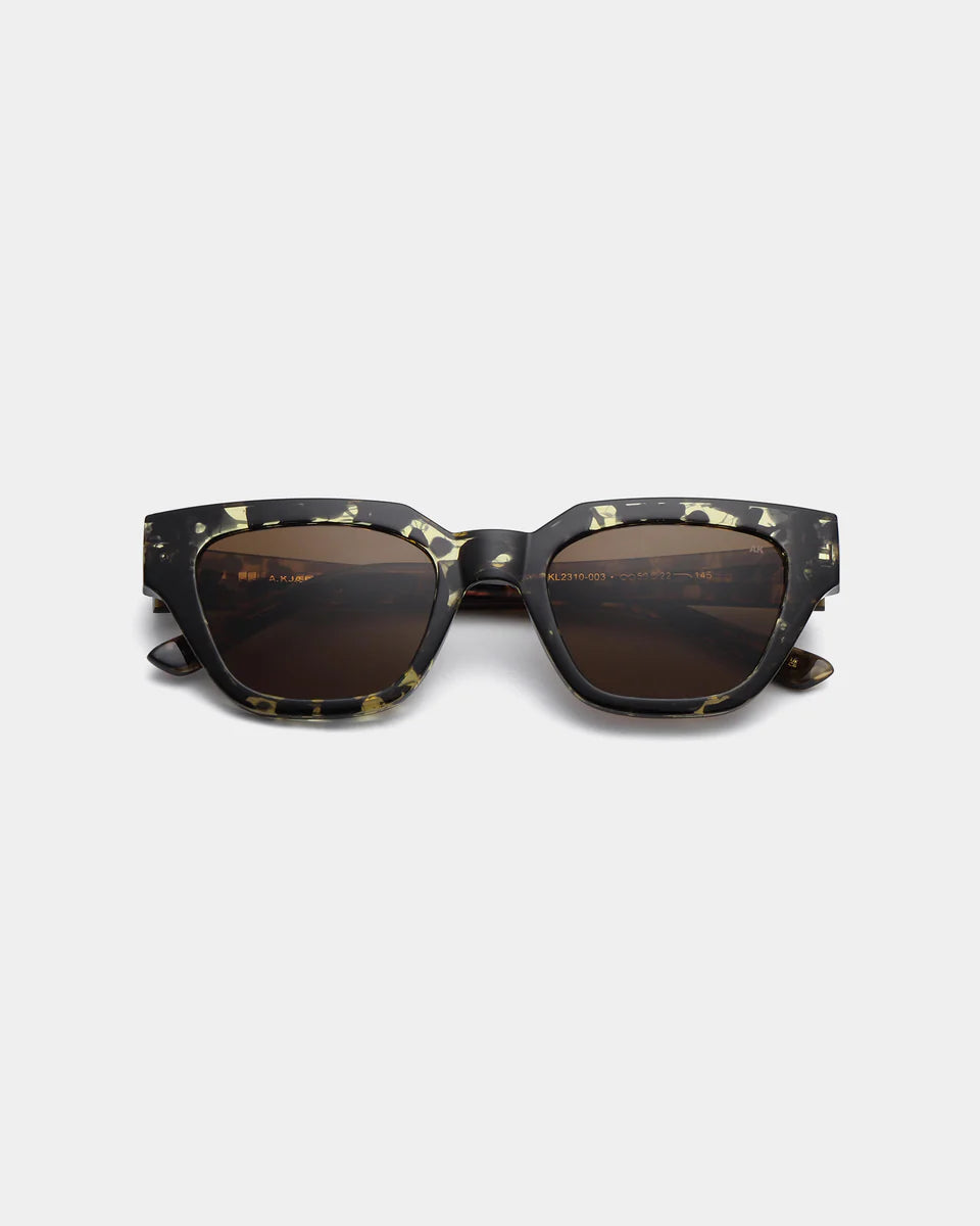 The Kaws Sunglasses - Black/Yellow Tortoise by A. Kjærbede feature a rectangular frame with dark lenses, black and yellow tortoiseshell pattern, and UV 400 protection, displayed against a plain white background.