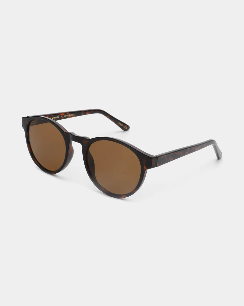 A. Kjærbede Marvin Sunglasses in Demi Tortoise: round unisex frames with dark tinted lenses, made from recycled materials, shown on a white background.