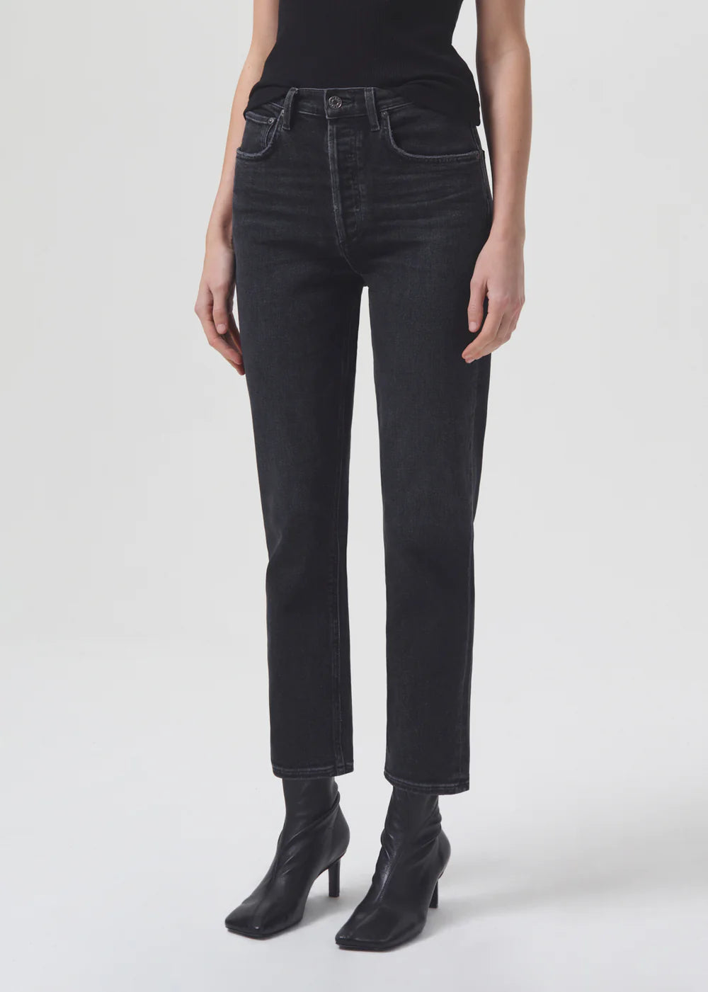 A woman wearing AGOLDE Riley Straight Crop - Panoramic black jeans.