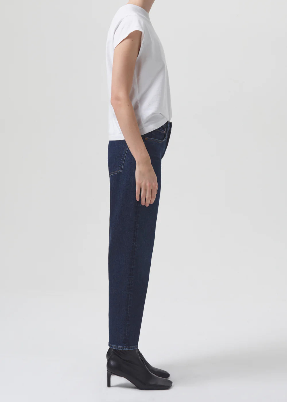 The model is wearing a white t-shirt and AGOLDE Kye Straight Crop - Song jeans.