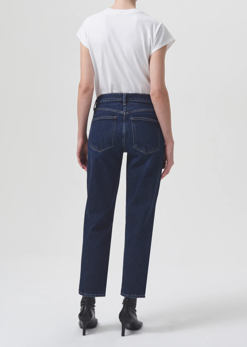 The back view of a woman wearing a white t-shirt and jeans with AGOLDE Kye Straight Crop - Song silhouette.