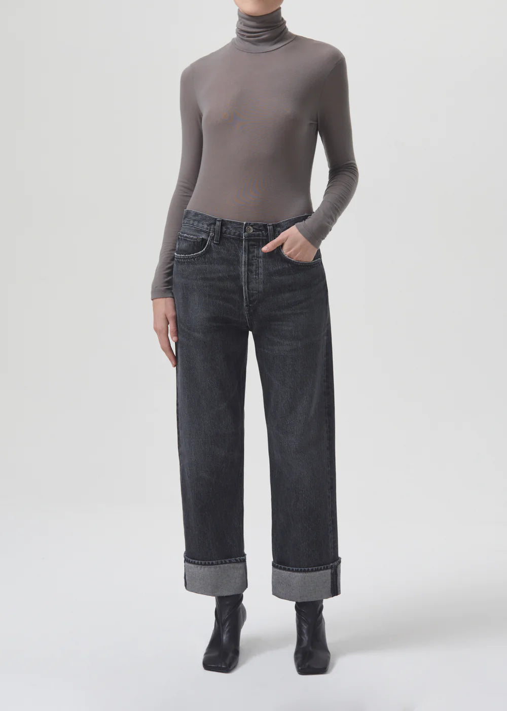 The model is wearing a turtle neck top and AGOLDE Fran Low Slung Straight - Ditch jeans.