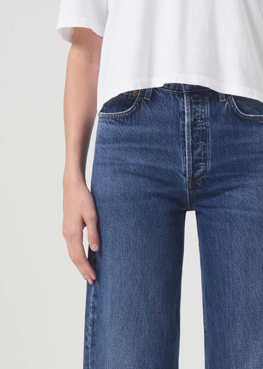 model wears blue wide leg jeans