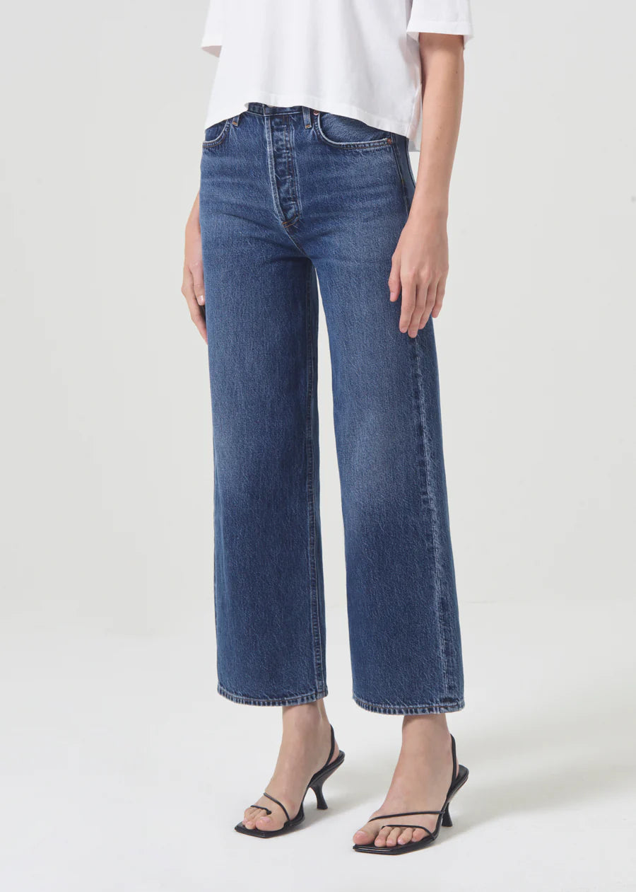 model wears wide leg blue jeans