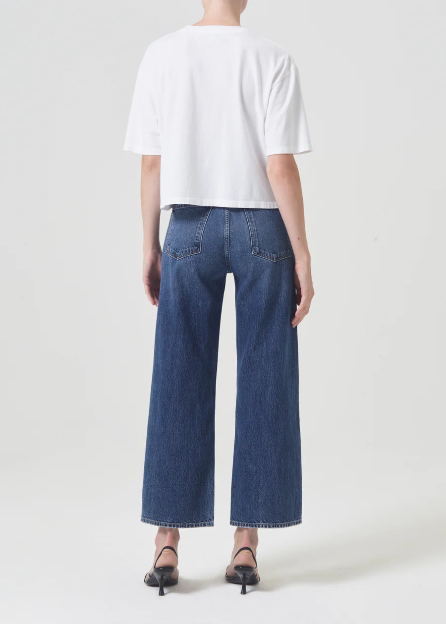 model wears wide leg blue jeans