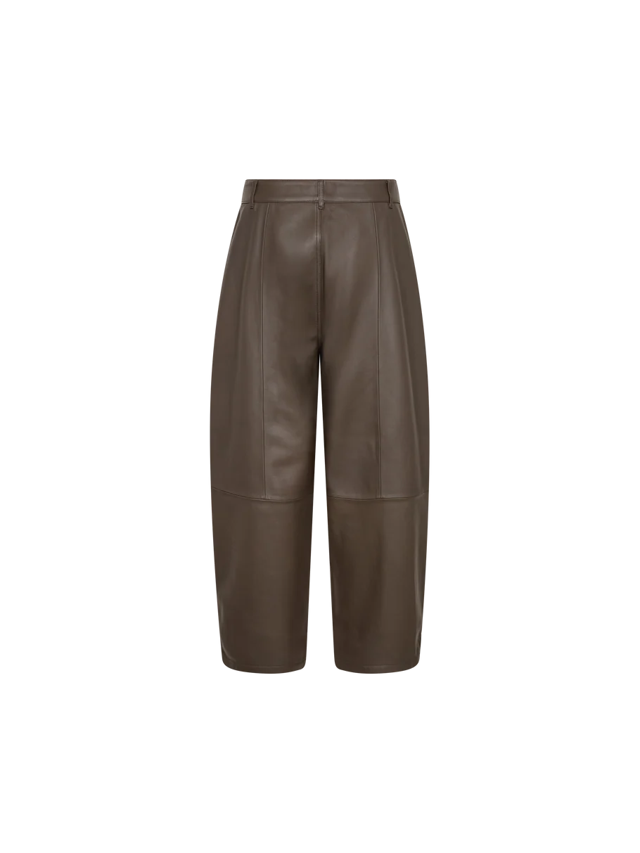 The MOS MOSH Barrel Leather Pant is a pair of brown, knee-length shorts crafted from supple lamb leather, featuring front seam detailing, belt loops, and a clean tailored design with a subtle barrel-leg silhouette, shown against a plain white background.