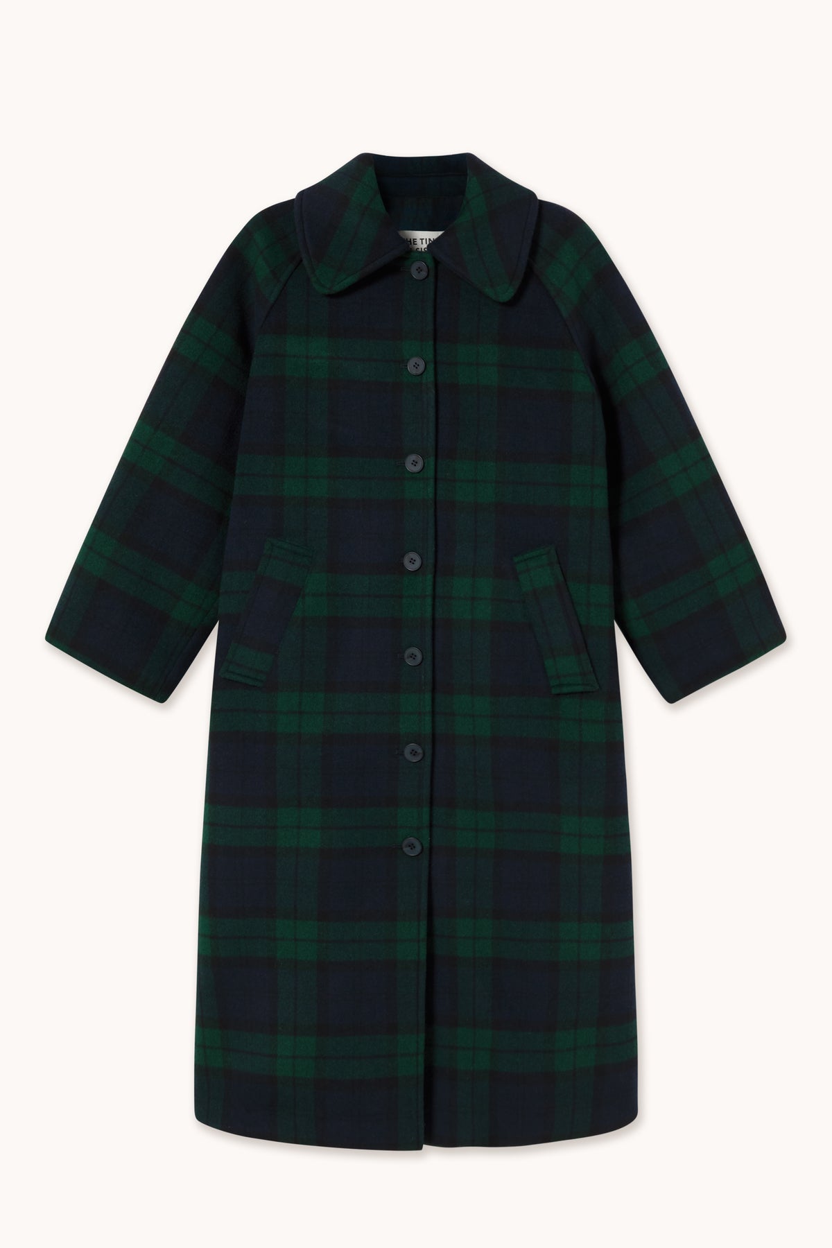 A long-sleeved button-front coat in a dark green and black plaid pattern, featuring a pointed collar and front pockets, shown against a plain off-white background.