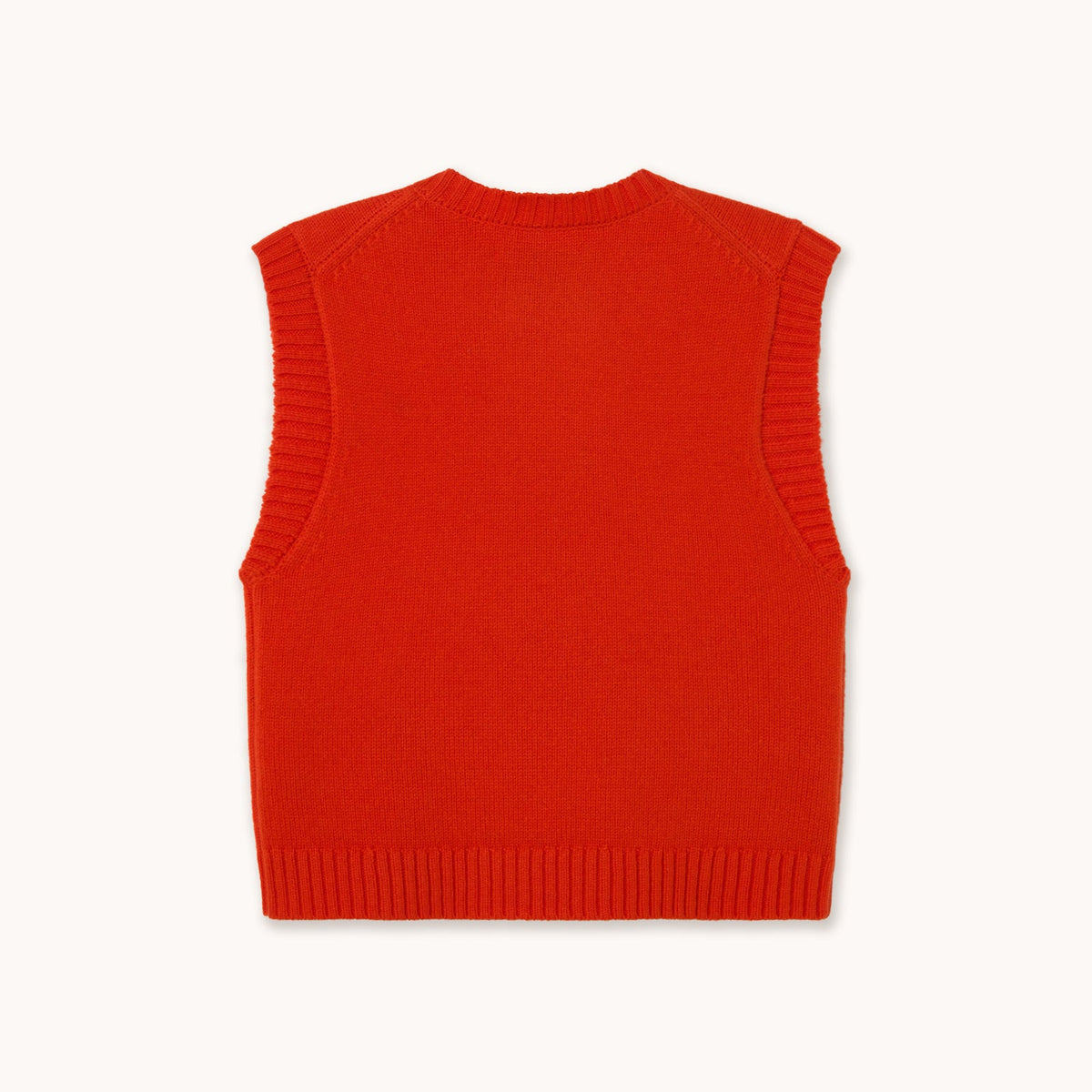 A bright red ribbed knit vest with a button-up front, displayed flat against a light off-white background. The brand label 'THE TINY BIG SISTER' is visible inside the collar.