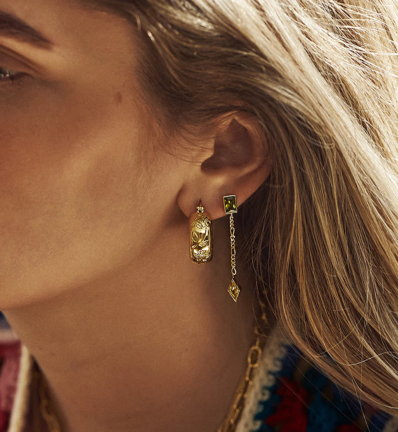 model wearing flower stamped gold hoop earrings